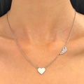 Silver heart and wing necklace on female model neck with delicate metal chain - Silver Heart Wings (8269)