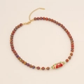 Beaded necklace with evil eye cylinder pendant and colorful striped beads on beige base - Red Malachite Style (WILL/Eye Pattern)