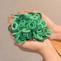 Bulk high-elastic hair ties in various green shades held in hands for toddlers - Green Stripe Series 100Pcs OPP Bag