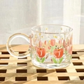 Glass tulip mug with gold handle and stars design on a wooden surface - Clear Tulip Painted Mug