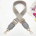 Detail of adjustable grey nylon shoulder strap with gold swivel hooks and leather ends - Light Gray & Gray