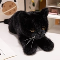 Realistic black kitten plush toy with soft fur and amber eyes in lying position - Black Cat