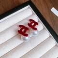 Detail of red flocked CC logo stud earrings with white pearl drops on jewelry box - Red Flocked Cross-Curved Pearl Earrings (17# Silver Earring Post-Red)