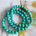 Close-up of 8mm turquoise stone bead bracelet with natural white and brown textures - Imitation Regal Stone Green