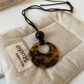 Detail of tortoiseshell resin pendant on black beaded cord with minimalist aesthetic - 4# Brown Necklace