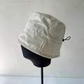 Light gray bucket hat with adjustable drawstring and side logo patch for women - White