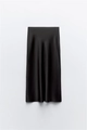 Detailed view of black satin midi skirt with glossy silk texture and elegant draping - XS / Black