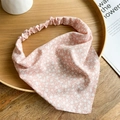 Detailed close-up of pink floral chiffon kerchief with elastic band on wooden tray - Pink
