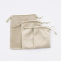 Trio of beige velvet drawstring pouches in small medium and large sizes on white background - 7*9cm / Beige