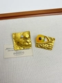 Detail of vintage gold-tone earrings with hammered texture and eye-shaped emerald design - 27 Yellow Demon Eye Earrings Eh1361