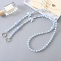Blue acrylic pearl crossbody phone strap with butterfly and rose beads on grey background - K3530 Pearl Bowknot Heart Chain Light Blue