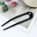 Minimalist black U-shaped hair pin for buns with a glossy finish on a floral card - Glossy Black