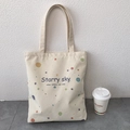 Detail of off-white canvas tote bag with colorful polka dots and Starry Sky text - Starry Sky Beige