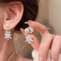 Macro view of snowflake pearl earring with delicate pavé crystals and silver finish - Silver Snowflake Pearl Pendant Stud Earrings