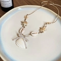 Detailed shot of handmade shell necklace with starfish and pearl bow on a ceramic plate - 16# Wax Rope Starfish Shell Bow Necklace