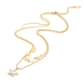 Detail of double-layer gold star necklace with white shell inlay and sleek ball chain links - Gold C516