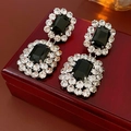 Macro detail of geometric earrings featuring black rectangular stones and white rhinestones - Black