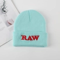 Light blue knit beanie featuring red RAW embroidery and thick cuffed edge for winter - One Size / Light Blue