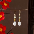 Classic Chinese style earrings with white teardrop pendant and golden leaf details - White Tear Drop Emerald Accents (E903-7)