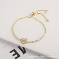 Adjustable gold sunflower bracelet with crystal zircon petals on a white display stand - White Flower