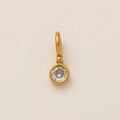 Macro view of a 18K gold plated pendant with a clear sparkling round cubic zirconia - April Round Birthstone Pendant Only (Without Chain)