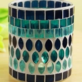 Blue mosaic glass tea light holder with teardrop pattern on a wooden table - Blue