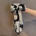 Retro bow hair clip with black and white floral print and long ribbon streamers - Black Camellia Print Ribbon