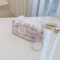 Detail of lavender tweed fabric texture with pearl strap and golden zipper on mini bag - Tweed Lavender