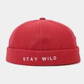 Detailed close-up of red docker cap featuring white STAY WILD embroidery and canvas texture - Adjustable / Red