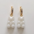 Detail of gummy bear earrings with gold hoops, sparkling white resin, and inlaid crystals - Jelly White