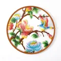 Vibrant round metal wall hanging featuring a colorful bird on a blossoming flower branch - Bird and Flower