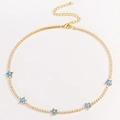 Close-up of golden necklace featuring a blue zircon flower with lobster clasp and chain - Blue