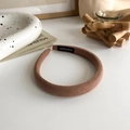 Close-up of brown knitted headband with white handmade label on natural white desk - Light Coffee