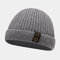 Detailed view of the thick gray ribbed knit texture and woven label on a winter beanie - One Size / Gray