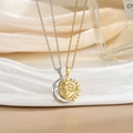 Macro shot of silver moon and gold sun necklaces on elegant champagne silk fabric - Magnetic Couple Necklace XL0481B (Gold/Silver Classic Sun Moon)