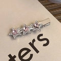 Macro detail of silver star hair clip with pink crystal and pavé rhinestones - Triple Pink Star Rhinestone Clip