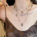 Close-up detail of vintage ethnic layered necklace with pearls and hollow heart charms - 43# Necklace - Bronze Tone