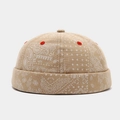Detail of khaki Paisley Miki hat showing intricate white patterns and red embroidered eyelets - Adjustable / Khaki