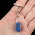 Deep blue rectangular gemstone keychain with silver metal ring held in hand - Blue Aventurine