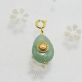 Waterdrop-shaped light green stone pendant with gold sunburst detail and clasp - Light Green Gemstone Teardrop