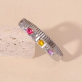 Elastic stainless steel bracelet with three oval gemstones and gold dot accents - Dark Color