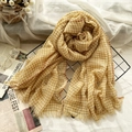 Lightweight yellow plaid wool scarf with fringes on a decorative metal grid background - Ginger Yellow Grid
