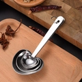 4-piece heart-shaped stainless steel measuring spoons set on a wooden tray with spices - Silver