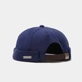 Detail view of the navy canvas miki hat featuring a brown leather adjustable back strap - Adjustable / Navy Blue