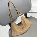 Detail of a gold rhinestone mesh hobo evening bag with woven knot strap on a grey chair - Standard Size / Gold Base White Zirconia
