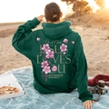 Dark green oversized hoodie featuring pink cherry blossom print and Jesus Loves You text - S / Dark Green