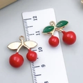 DIY cherry pendant charms in red enamel and gold finish with a ruler for size scale - Drip Oil Cherry (23413)