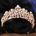 Detailed view of floral bridal tiara with pink crystals and clear rhinestones on velvet - KC Gold White Rhinestone + Pink Opal