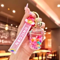 Pink unicorn liquid sand keychain with silicone strap and bell in a clear bottle charm - Glow-in-the-dark Rainbow Candy Beans [cola Can]