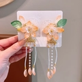 Hanfu style hair clips featuring orange and green translucent flowers with golden tassels - Orange Shell Flower Clips